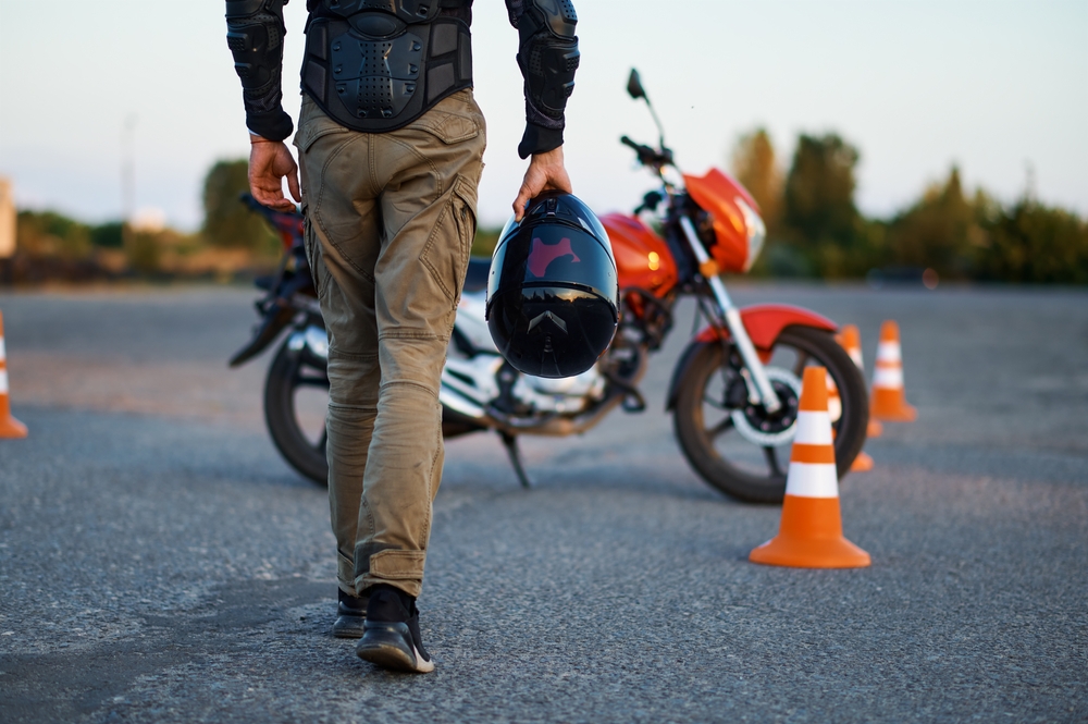 Male-Person-Holds-Helmet-Motorcycle-School